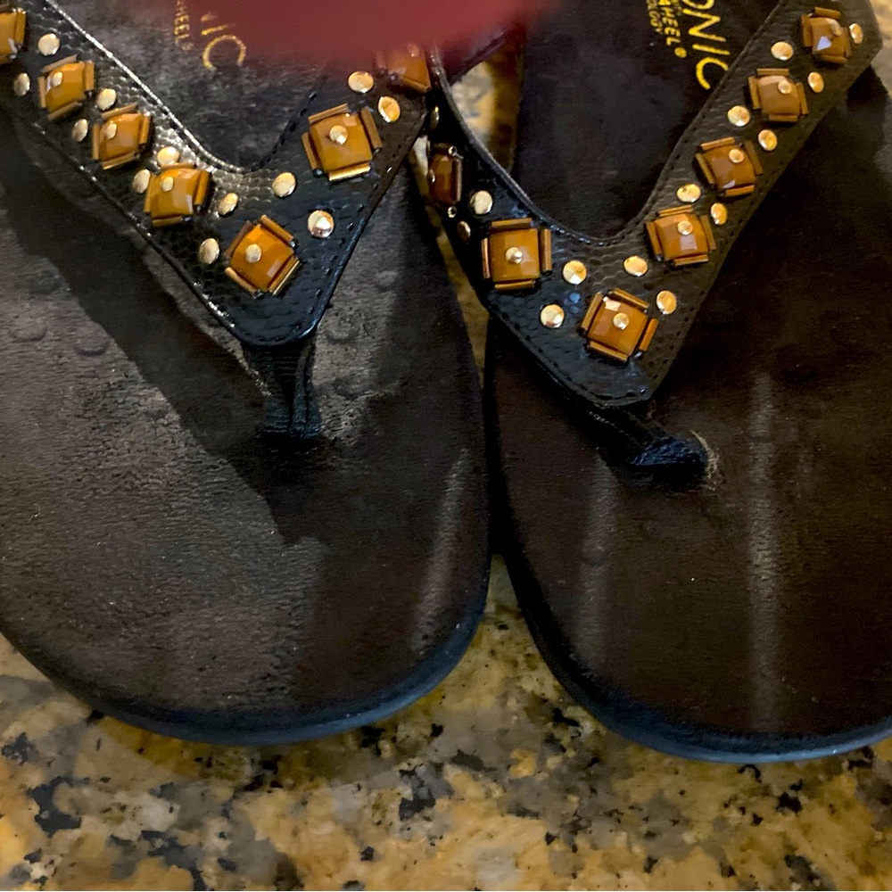 Black Vionic flip flops - gold and brown trim- size 7.